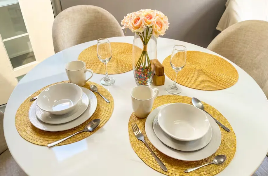 Dining table overhead with roses and wine glasses, Tocumen apartment